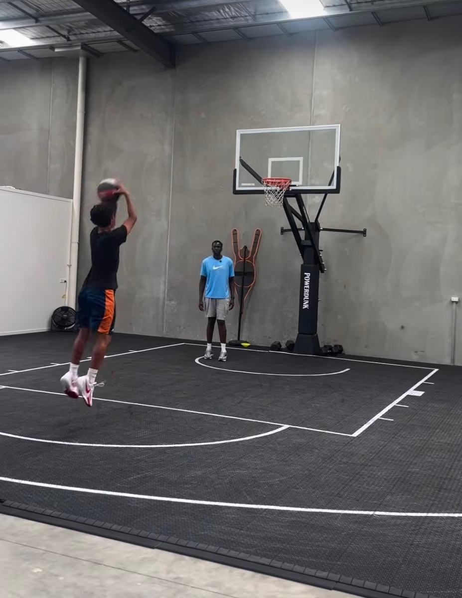 Player taking a jump shot on an indoor training court