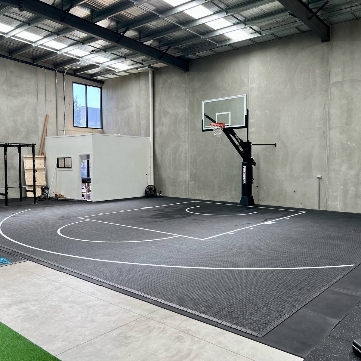 Indoor warehouse basketball court with a wall-mounted hoop