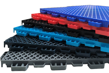 Stack of modular court tiles in blue, red, black, cyan and grey