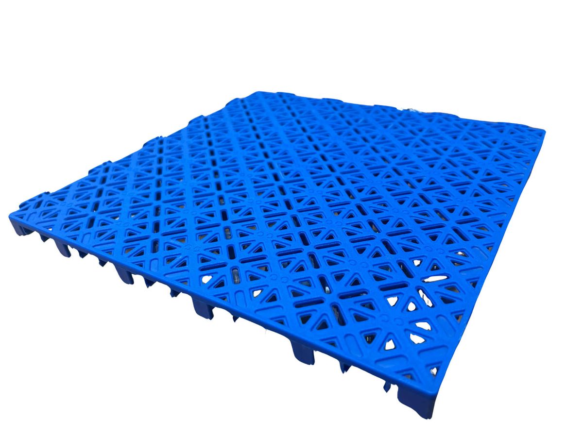 Top playing face of a blue modular court tile